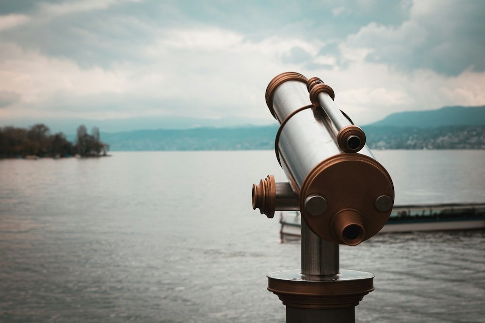 Telescope overlooking a lake, representing better search visibility on Mac